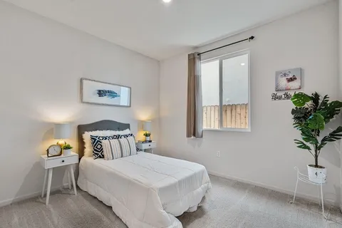 a bedroom with a bed and chair