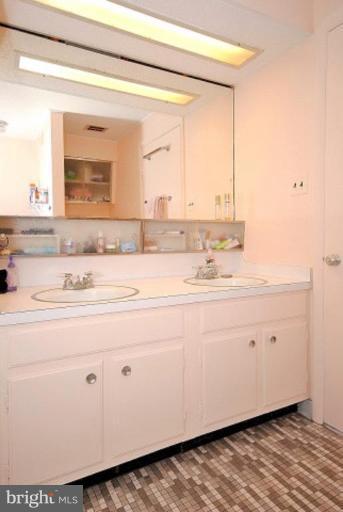 3112 Sleepy Hollow Road Falls Church, VA 22042 - Photo 19 of 20 a bathroom with a sink mirror and vanity