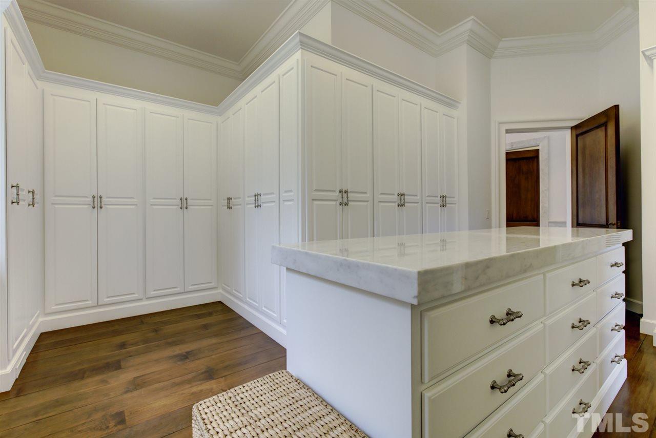 648 Tant Road Spring Hope, NC 27882 - Photo 18 of 30 The His & Her dressing rooms feature cabinets, a center island with cabinets, and special doors for shoes to allow air flow.