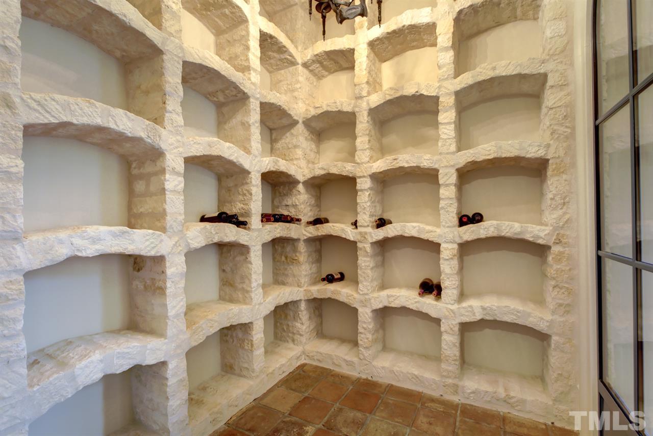 648 Tant Road Spring Hope, NC 27882 - Photo 10 of 30 Custom wine storage room with an antique French café door and limestone racks.