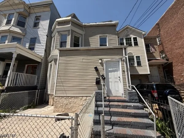a front view of a house with stairs