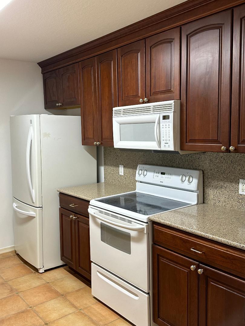 a kitchen with a stove cabinets and refrigerator