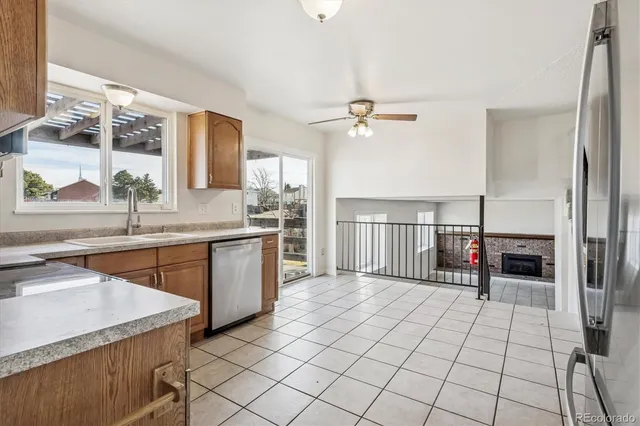 a open kitchen with stainless steel appliances granite countertop a sink and a refrigerator