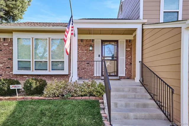 a view of a house with potted plants