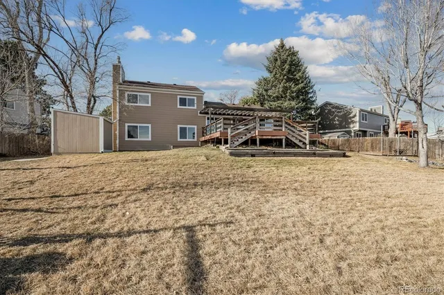 a white house that has a tree in front of it
