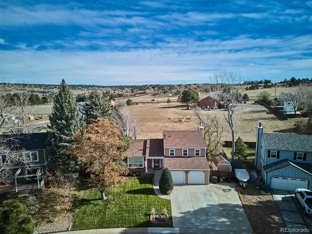 an aerial view of a house with a yard