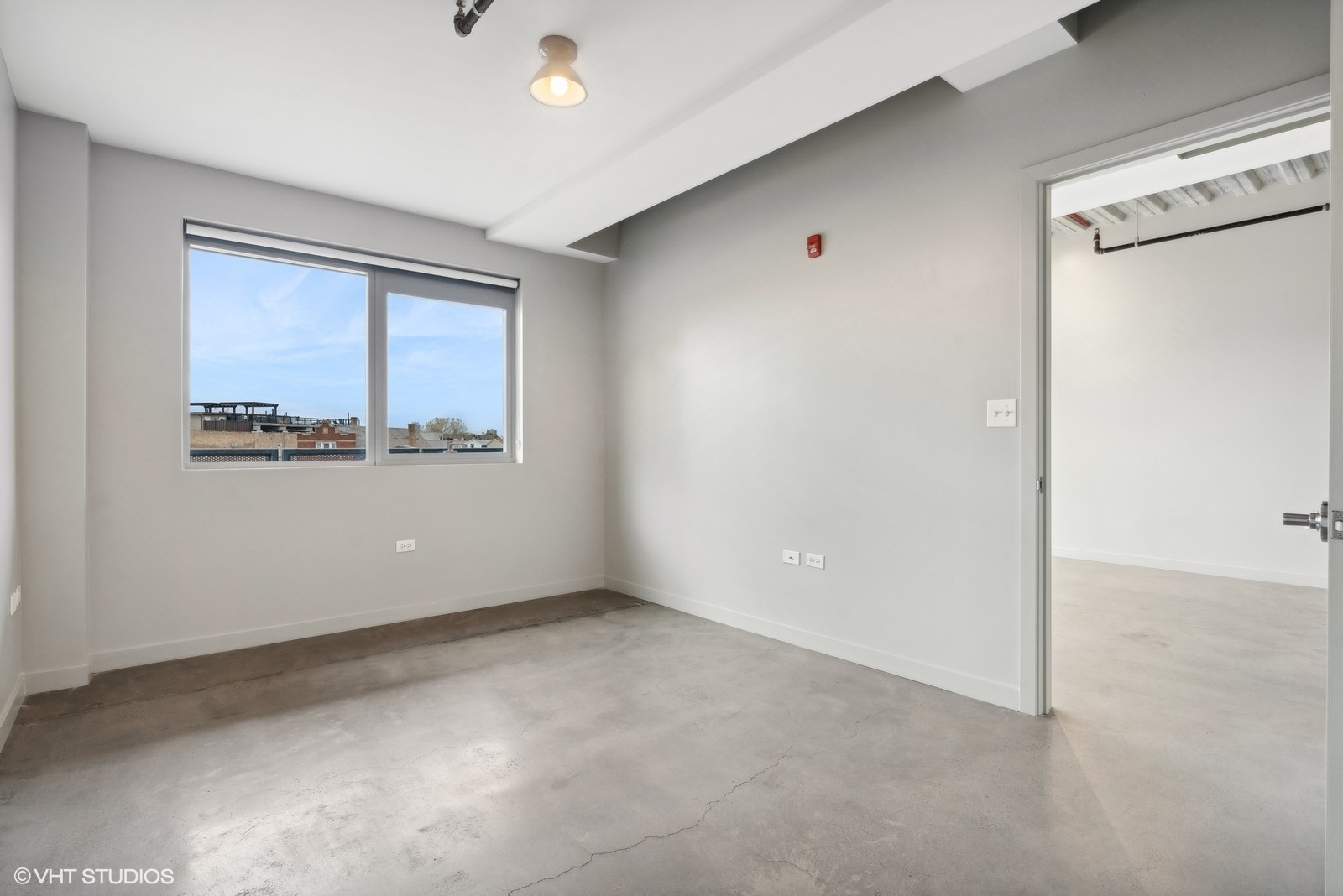 1241 North Milwaukee Avenue, Unit 404 Chicago, IL 60622 - Photo 10 of 11 a view of an empty room with a window