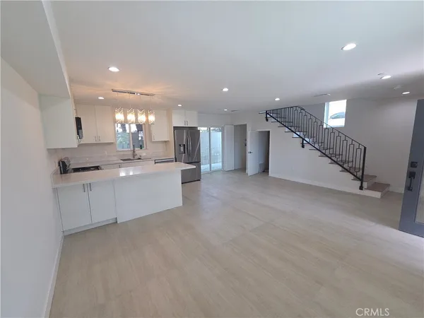 a large white kitchen with a white kitchen oven a sink and a dishwasher