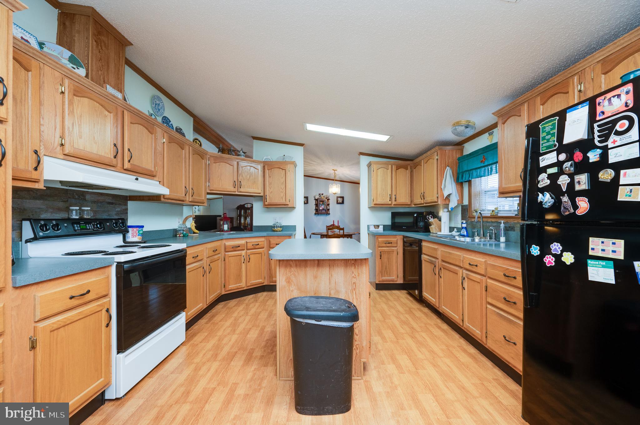 400 Allenbrook Lane Reading, PA 19606 - Photo 14 of 27 a kitchen with stainless steel appliances granite countertop a stove a sink and a refrigerator