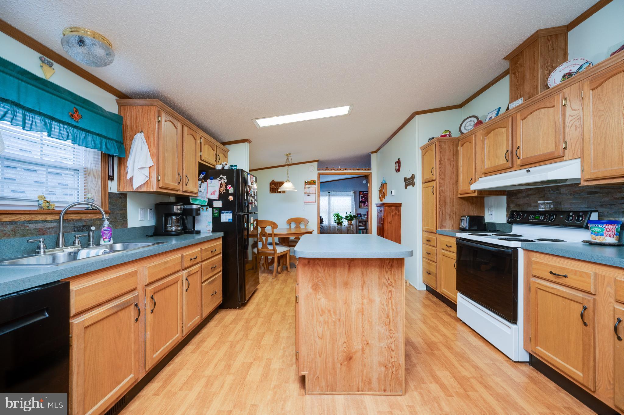 400 Allenbrook Lane Reading, PA 19606 - Photo 15 of 27 a kitchen with stainless steel appliances granite countertop a refrigerator a stove top oven a sink dishwasher and wooden cabinets with wooden floor