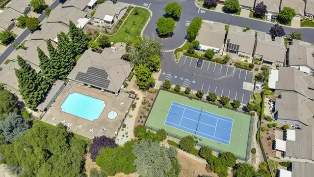 an aerial view of a house with a yard and swimming pool