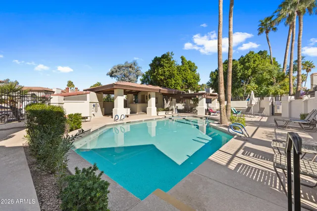 a view of a house with backyard porch and sitting area