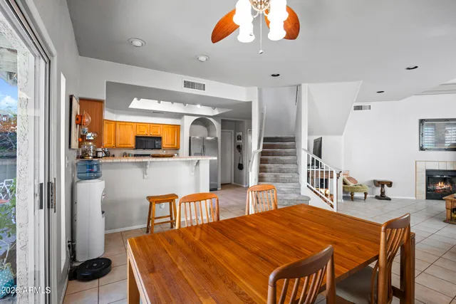 a dining room with stainless steel appliances kitchen island a chandelier