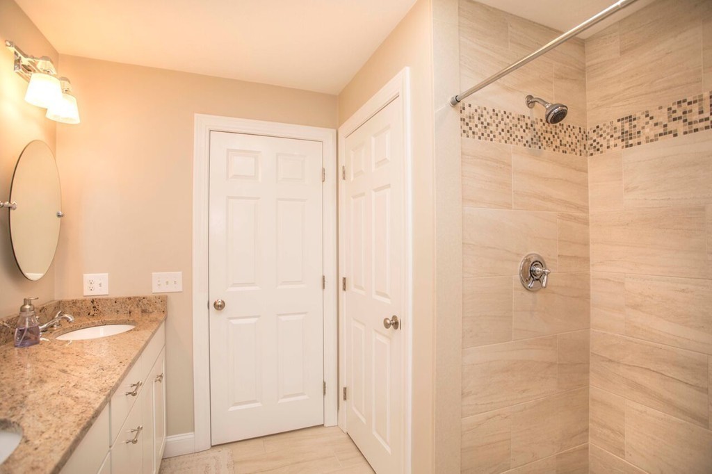 20 Strathmore Road East Bridgewater, MA 02333 - Photo 24 of 30 a bathroom with a granite countertop sink a mirror and shower