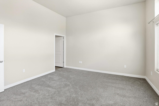 1838 West 300th Street South, Unit B Mapleton, UT 84664 - Photo 19 of 51 Spacious room featuring neutral wall paint, gray carpeting, white trim, a two-panel interior door, and window blinds