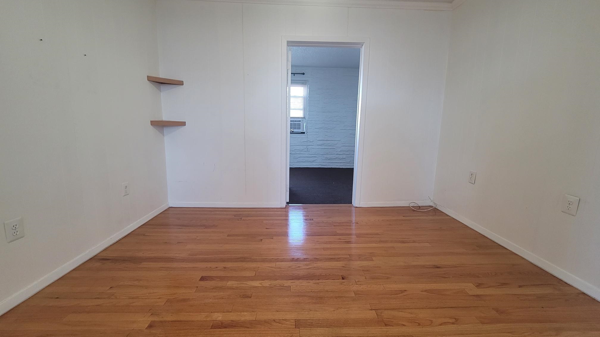 7 Magnolia Avenue, Unit 2 Jersey City, NJ 07306 - Photo 3 of 8 a view of an empty room with wooden floor and a window