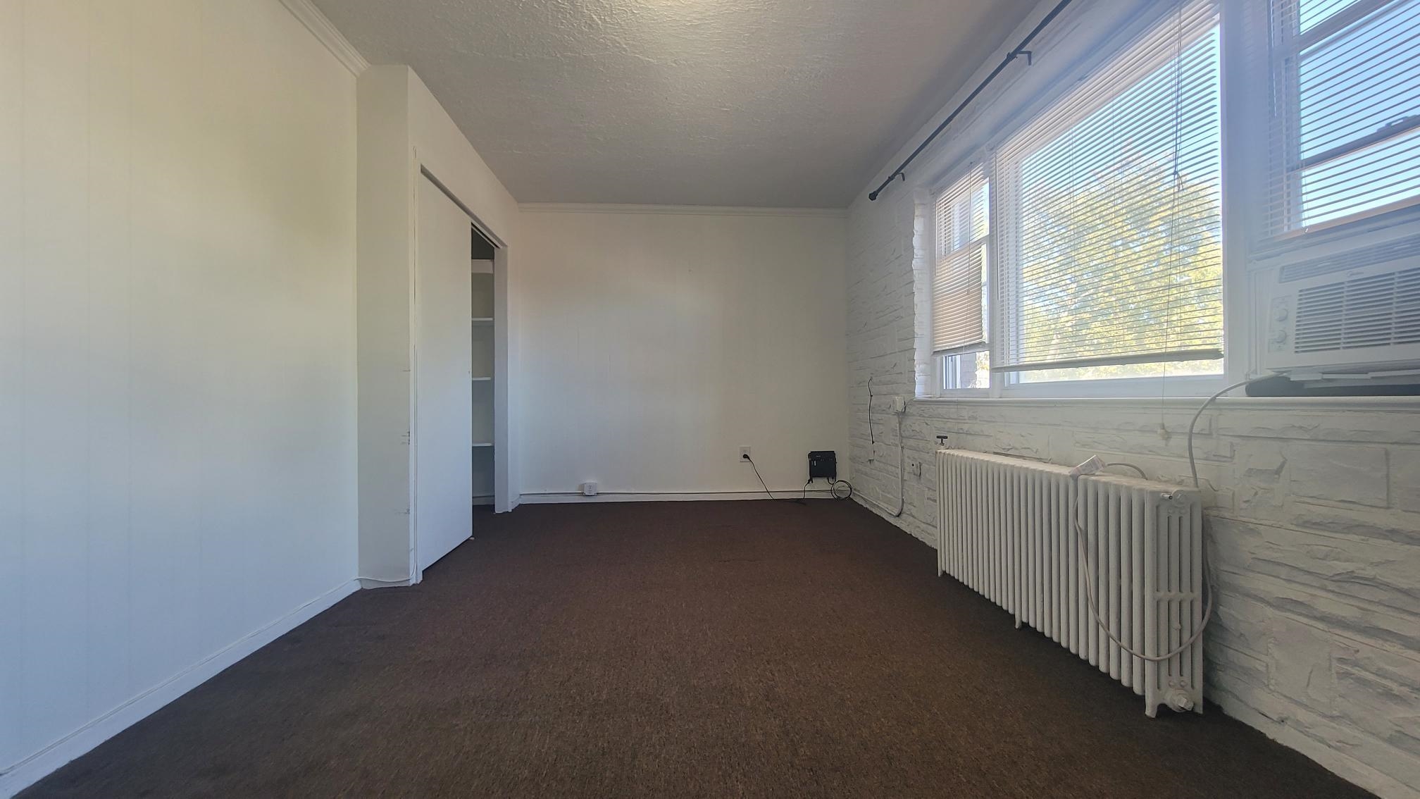 7 Magnolia Avenue, Unit 2 Jersey City, NJ 07306 - Photo 4 of 8 an empty room with a empty space and windows