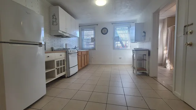a kitchen with stainless steel appliances a refrigerator sink and cabinets