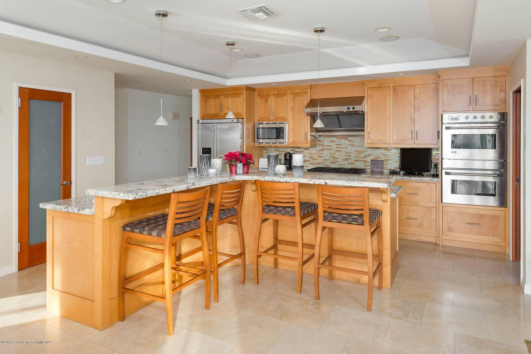 3430 Ellington Villa Drive Altadena, CA 91001 - Photo 12 of 49 a kitchen with stainless steel appliances granite countertop a stove a sink and a refrigerator