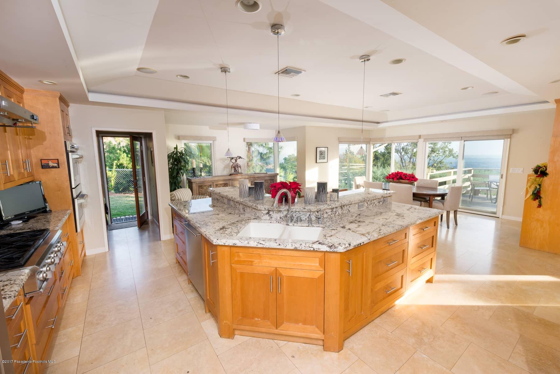 3430 Ellington Villa Drive Altadena, CA 91001 - Photo 13 of 49 a kitchen with granite countertop a stove and living room view