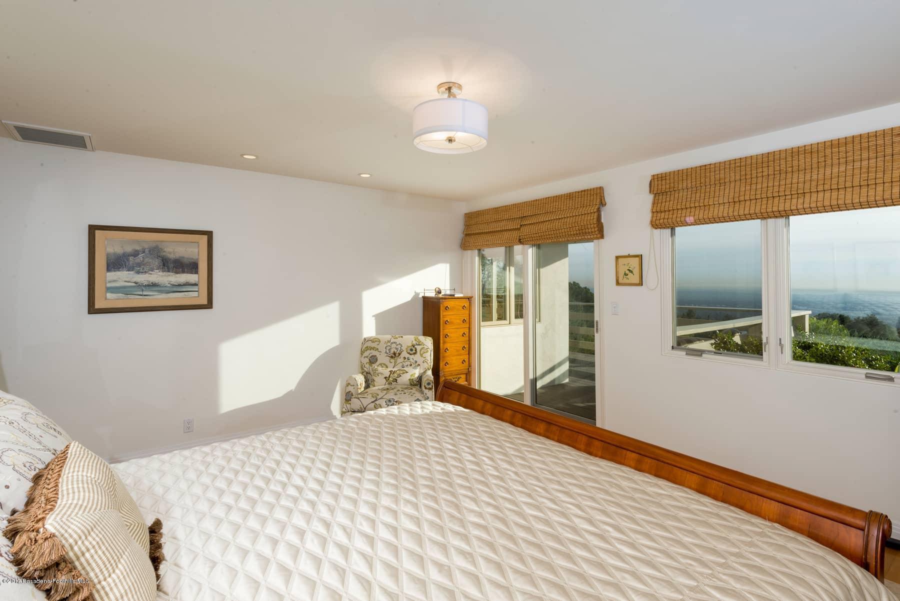 3430 Ellington Villa Drive Altadena, CA 91001 - Photo 21 of 49 a bedroom with a large bed and a large window