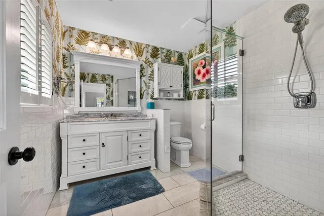 a spacious bathroom with a toilet sink and mirror