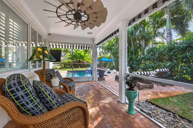a view of a porch with chairs and backyard