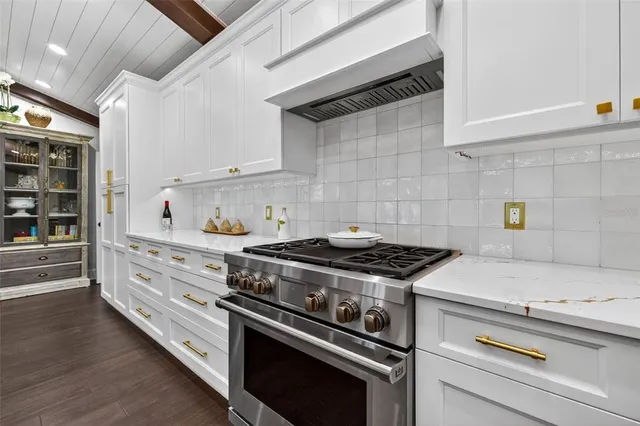 a white stove top oven sitting inside of a kitchen