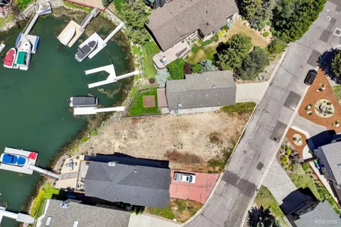 an aerial view of a house with a yard