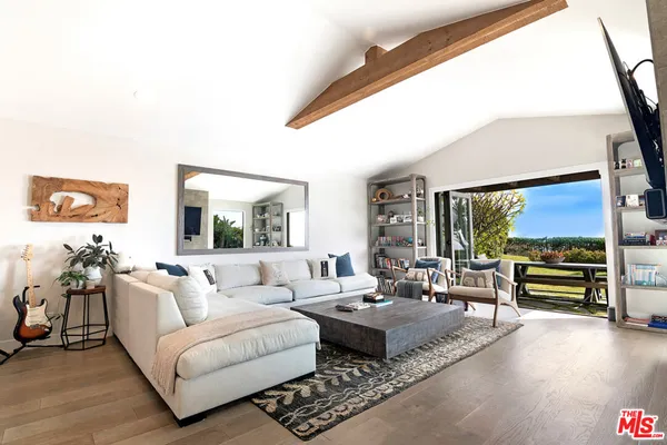 a living room with furniture and a large window