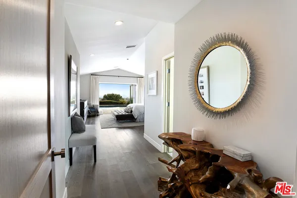 a living room with furniture and a mirror