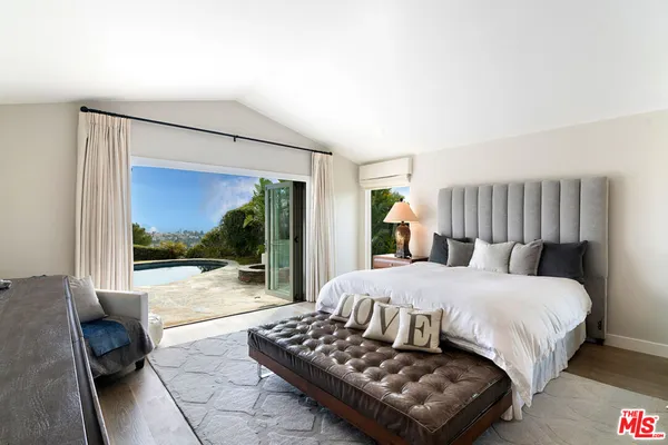 a bedroom with a bed and glass window