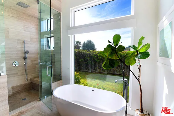 a white bath tub sitting next to a white toilet