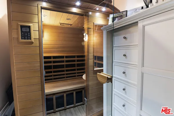 a bathroom with a shower and a mirror