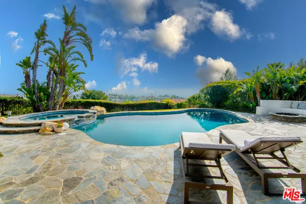 a view of a swimming pool with lounge chairs