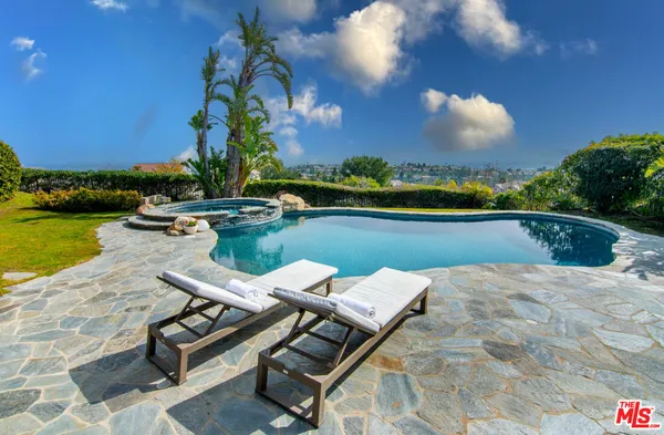 a view of swimming pool with a table and chairs