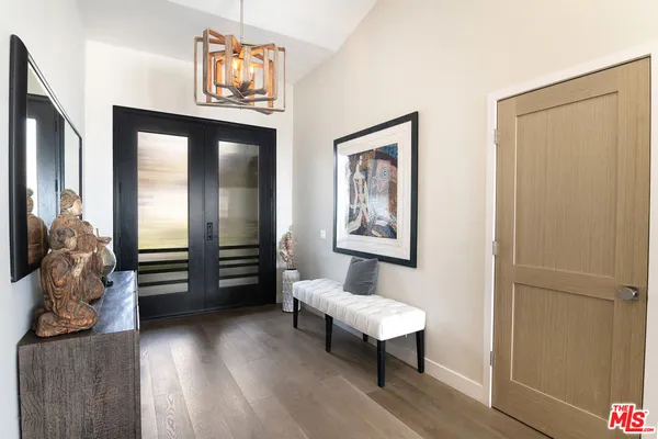a bedroom with furniture and a wooden floor