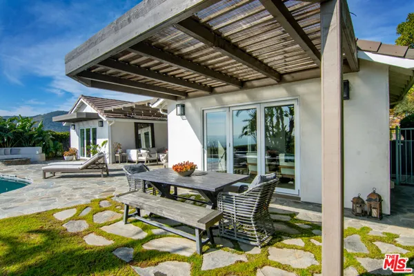 a view of a patio with swimming pool table and chairs