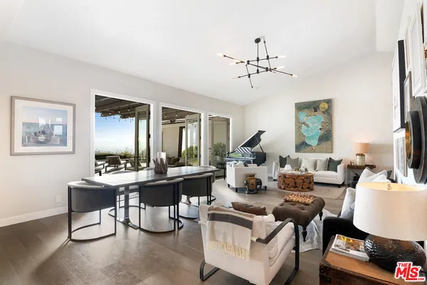 a living room with fireplace furniture and a large window