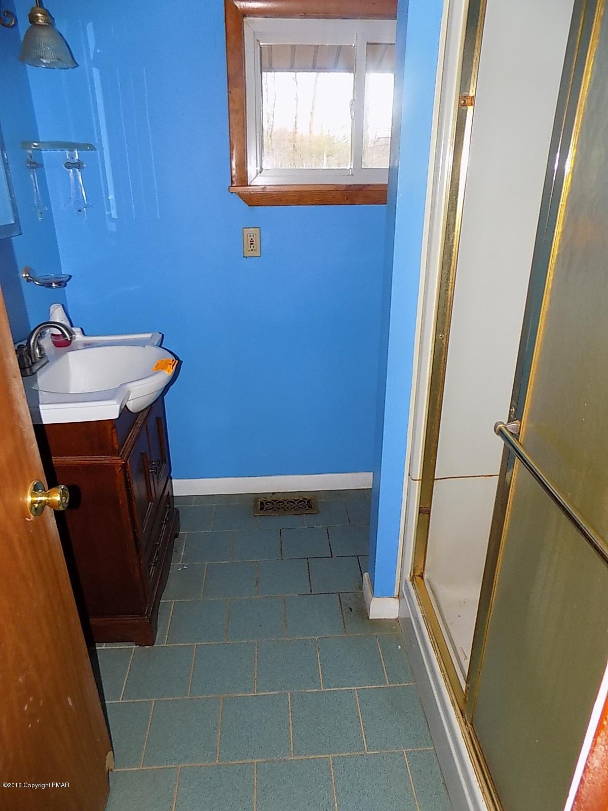 118 Beech Road Dingmans Ferry, PA 18328 - Photo 6 of 9 a bathroom with a sink and a mirror