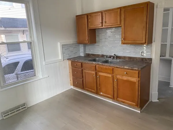 a kitchen with stainless steel appliances granite countertop a sink and a stove