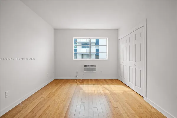 a view of a room with wooden floor and window