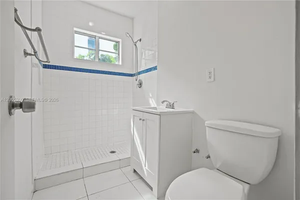 a white toilet sitting next to a bathroom sink