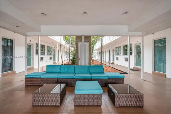 a room with pool table and windows