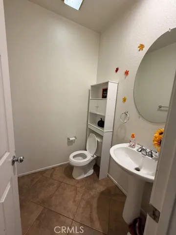 a white toilet sitting next to a bathroom sink