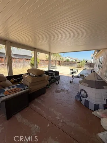 a living room with gym equipment and large windows