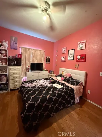 a bed room with a bed and a television