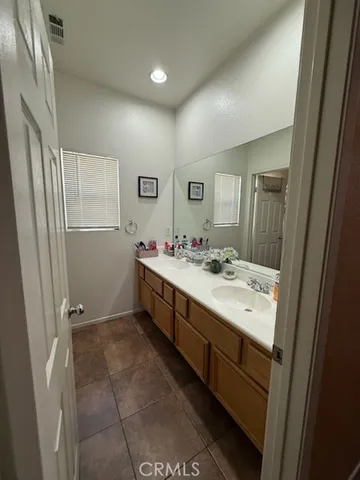 a bathroom with a sink a mirror and a shower