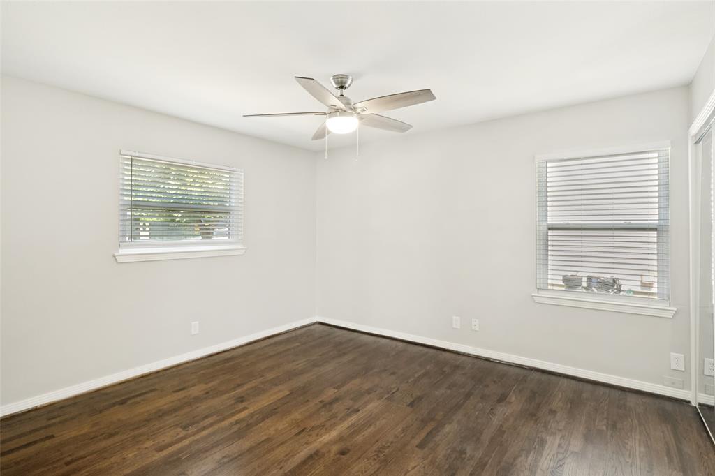 11524 Strand Street Dallas, TX 75218 - Photo 13 of 19 a view of an empty room with wooden floor and a window