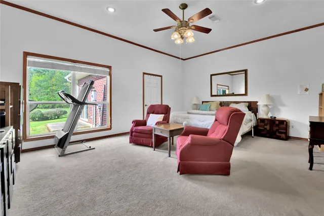 a living room with furniture gym equipment and a window